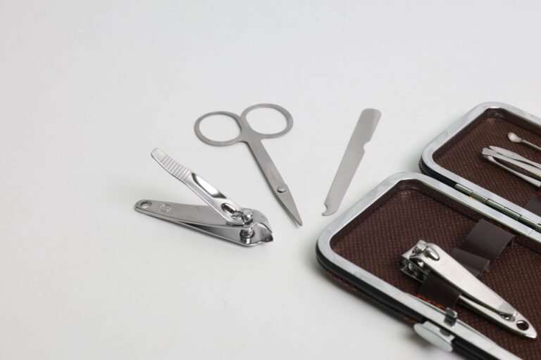 Close-up of a manicure set with nail clippers and tools on a white background
